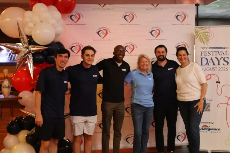 The Boca Helping Hands team at the Boca Chamber Festival Days backdrop