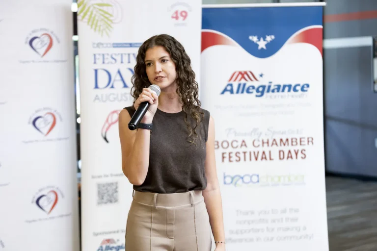 A speaker addressing bowlers at the Festival Days banner