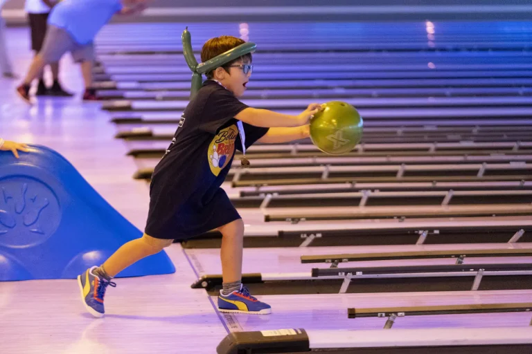A young bowler winding up to roll