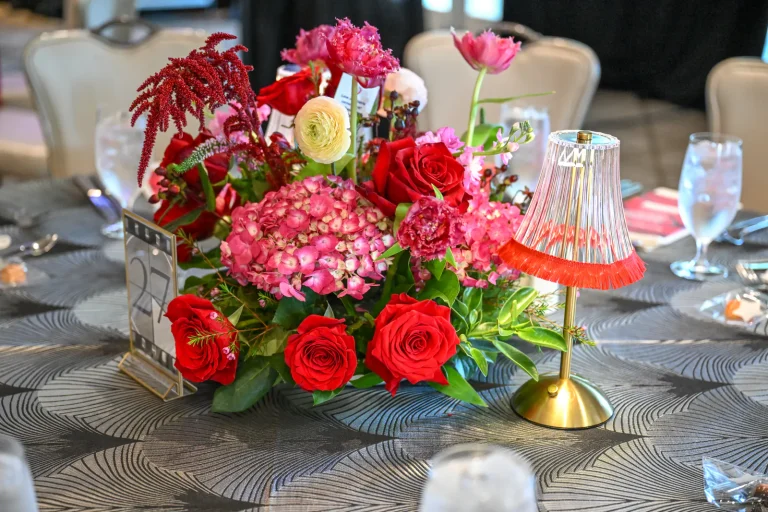 Red and pink floral centerpiece on a gala table