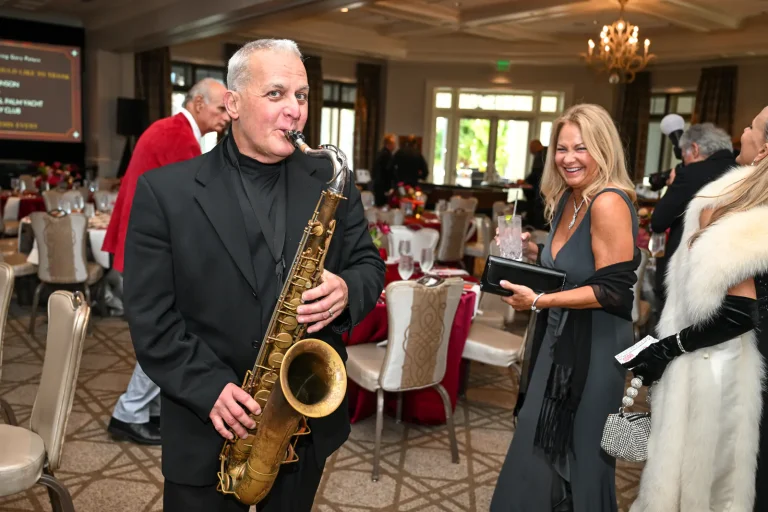 A saxophonist playing for guests during the reception