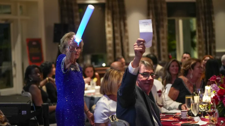 Guests raising paddles during the live auction