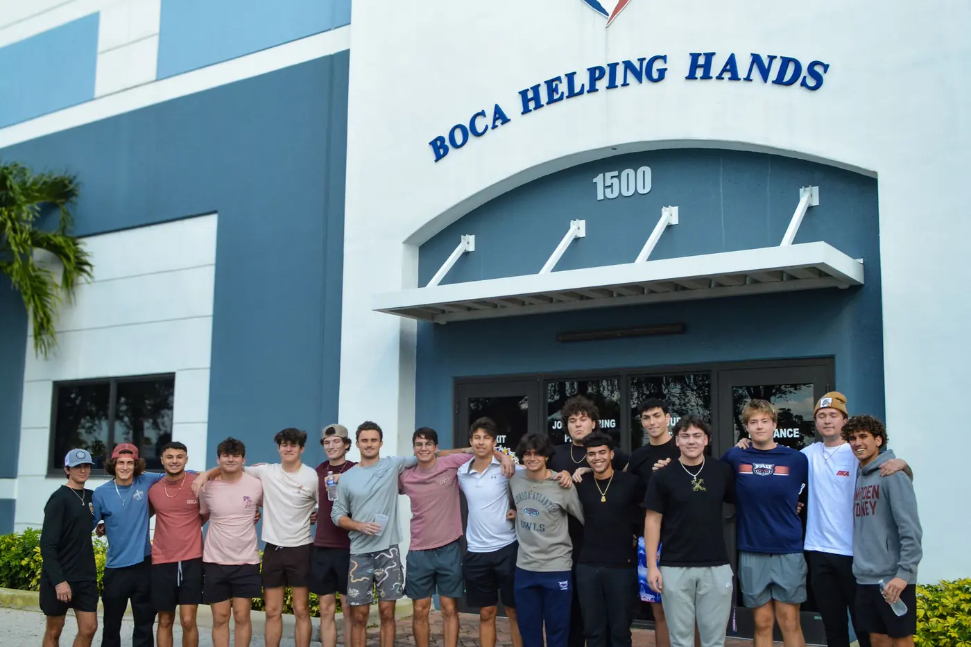 Large volunteer group outside the Boca Helping Hands building