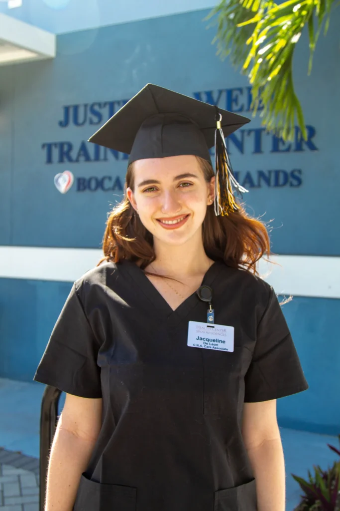 Workforce Development graduates holding certificates outside the Boca Helping Hands training center